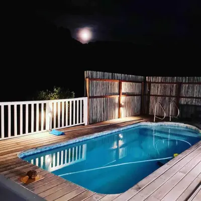 a swimming pool on a deck at night at Exquisite chalet on private nature reserve in Wolseley