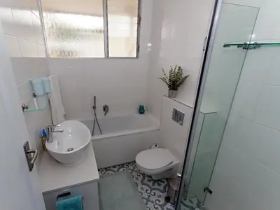 a bathroom with a toilet and a sink and a shower at Ocean-Song in Strand