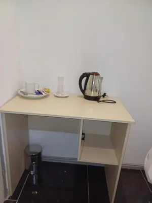 a table with a tea kettle on top of it at Ojong's Court Bellville in Cape Town