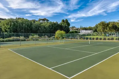 a tennis court with at Lord Charles Hotel, Somerset West, a Tribute Portfolio Hotel in Somerset West