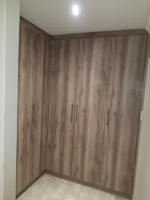 a room with wooden cabinets in a room at Prince Olive in Cape Town