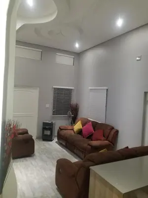 a living room with two couches and a table at Prince Olive in Cape Town