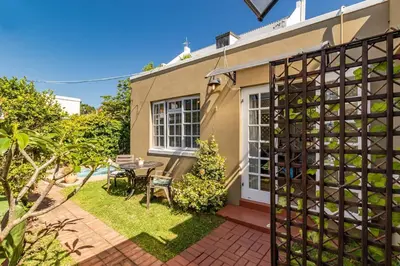 a home with a patio and a bunch of wine bottles at Suburban bliss with Wifi and plunge pool in Cape Town