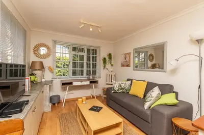 a living room with a couch and a table at Suburban bliss with Wifi and plunge pool in Cape Town