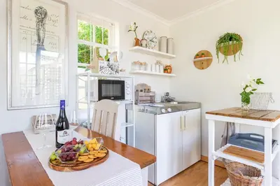 a kitchen with a table with a plate of fruit on it at Suburban bliss with Wifi and plunge pool in Cape Town