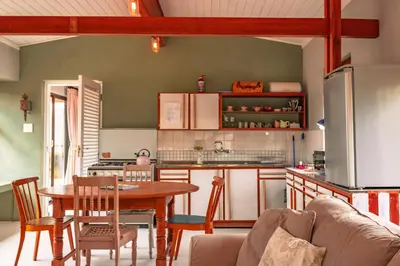 a kitchen with a table and a dining room at Edible Shores in Pringle Bay