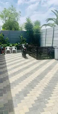 a motorcycle parked on a patio with two chairs at SpaciousNetflix#Wifi#Parking#CentralWinefarms#Mall in Cape Town