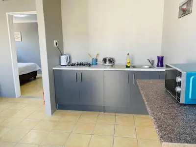 a kitchen with a sink and a counter top at SpaciousNetflix#Wifi#Parking#CentralWinefarms#Mall in Cape Town