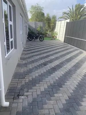 a motorcycle is parked next to a house at SpaciousNetflix#Wifi#Parking#CentralWinefarms#Mall in Cape Town