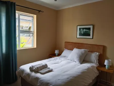 a bedroom with a bed with towels on it at 24 Wrench Glenlilly Parow in Cape Town