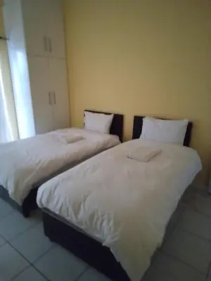 two beds sitting next to each other in a room at 24 Wrench Glenlilly Parow in Cape Town