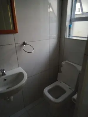 a bathroom with a toilet and a sink at 24 Wrench Glenlilly Parow in Cape Town