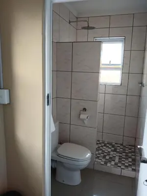 a small bathroom with a toilet and a window at 24 Wrench Glenlilly Parow in Cape Town