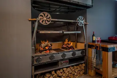 a pizza oven with fire inside of it at House w Pool, Fireplace, Braai in Cape Town