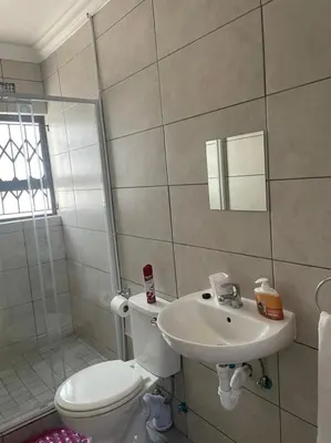 a bathroom with a toilet and a sink at Finca Guest House in Cape Town
