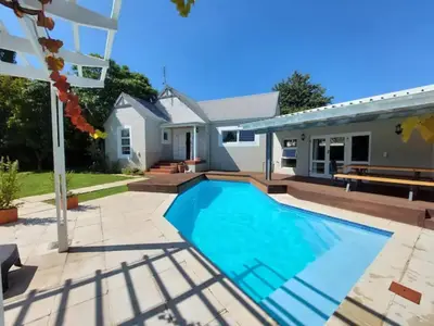 a swimming pool in the backyard of a house at A Touch of Country in Stellenbosch