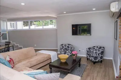 a living room with a couch and a table at A Touch of Country in Stellenbosch