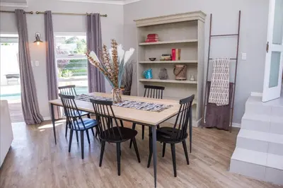 a dining room with a table and chairs at A Touch of Country in Stellenbosch