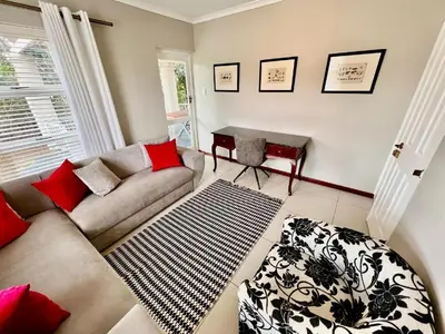 a living room with a couch and a table at A Touch of Country in Stellenbosch