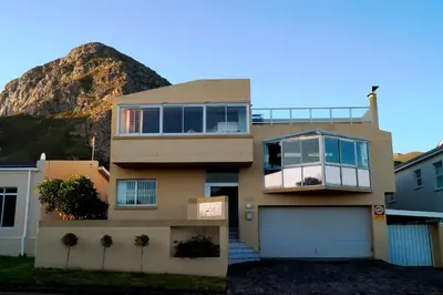 a house with a mountain in the background at Valentines Hermanus in Hermanus