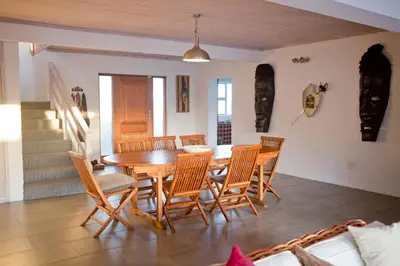 a dining room with a wooden table and chairs at Villa Del Mar in Clareport