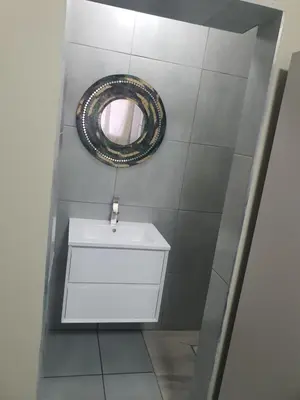 a bathroom with a sink and a mirror on the wall at Mabel Guesthouse in Cape Town