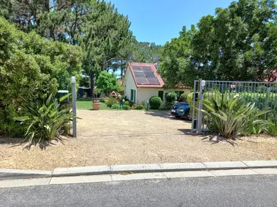 a gate in a yard next to a house at Wine Route 44 Guesthouse in Somerset West