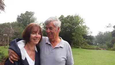 an older man and woman posing for a picture at Aloe Ocean Flatlet in Bettyʼs Bay