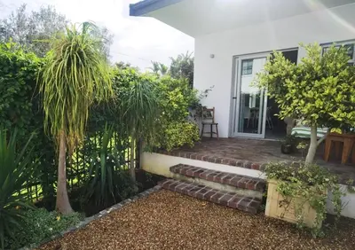 a house with a staircase leading to the front yard at Oak Village in Stellenbosch