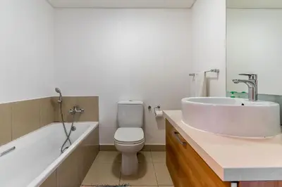 a bathroom with a sink and a toilet and a tub at Horizon Bay 1502 in Cape Town