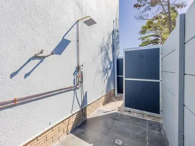 a street light on the side of a building at Southeaster in Bloubergstrand