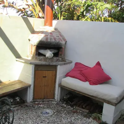 a bird house sitting next to a bench with a bird house at Sol Y Sombra in Bettyʼs Bay