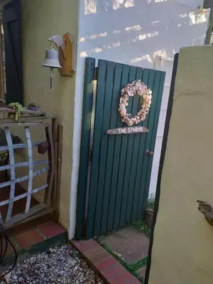a gate with a wreath on the door of a house at Sol Y Sombra in Bettyʼs Bay