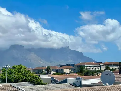 a view of a mountain from a city with buildings at Mowetu Guest House in Cape Town