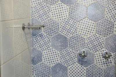 a shower with a blue and white tile wall at 3 on Roux in Franschhoek