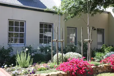 a garden in front of a house with flowers at 3 on Roux in Franschhoek