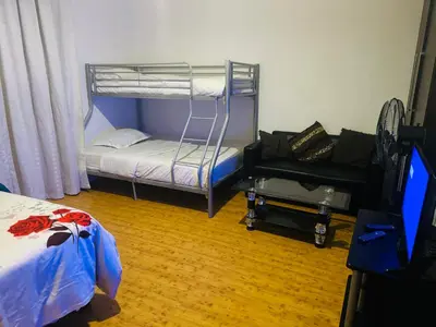 a bedroom with a bunk bed and a couch at Peaceful getaway in Cape Town
