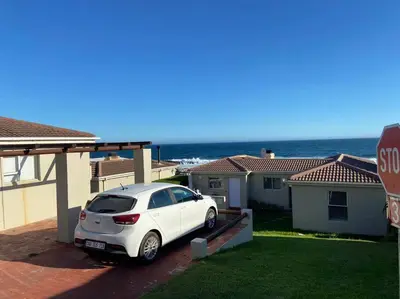 a white car parked in front of a house at Huis by die See in Hermanus