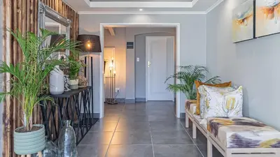 a hallway with a couch and potted plants at The Salene Hotel & Apartments in Stellenbosch