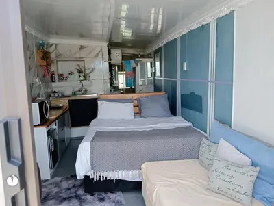 a small room with two beds and a couch at Cozy Private En Suite Studio in Cape Town