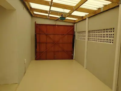 a garage with a large wooden door in a room at TERRA NOVA ACCOMMODATION - Unit Esmé in Cape Town