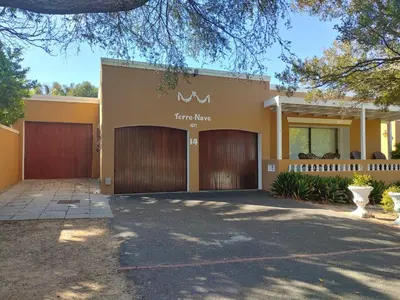 a house with two garage doors in a driveway at TERRA NOVA ACCOMMODATION - Unit Esmé in Cape Town