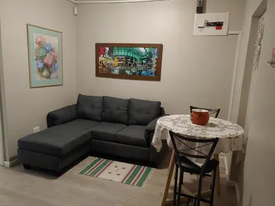 a living room with a couch and a table at TERRA NOVA ACCOMMODATION - Unit Esmé in Cape Town