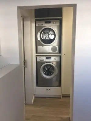 a hallway with a washer and dryer in a room at C'estÇa Cottage Modern Luxurious Sounds of the Sea in Hermanus