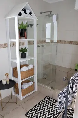 a bathroom with a shower with a glass shower stall at sonsandsee in Hermanus