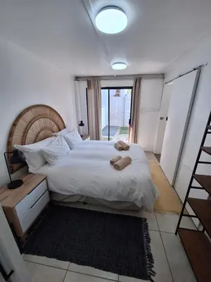 a bedroom with a bed with two slippers on it at Little Miracle in Worcester