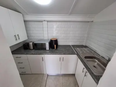 a small kitchen with a sink and a microwave at Little Miracle in Worcester