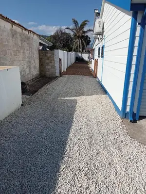 a cobblestone alley next to a white building at Glenley place in Hermanus