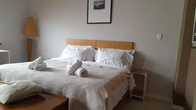 a bedroom with a bed with towels on it at Limbila House in Cape Town