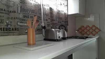 a kitchen counter with a counter top with a knife and fork at Limbila House in Cape Town
